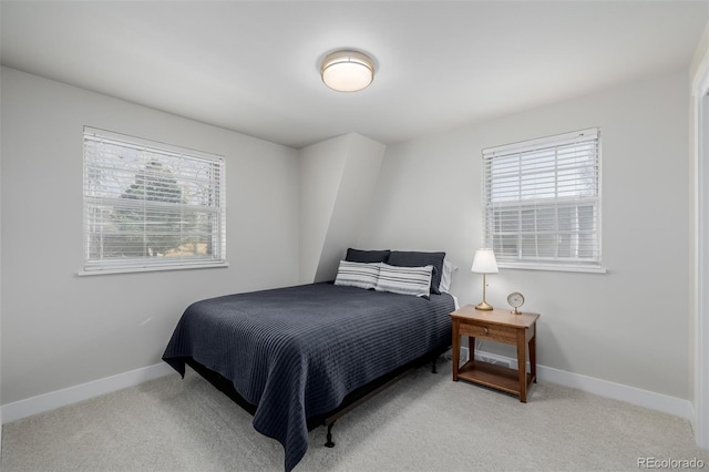 carpeted bedroom featuring multiple windows