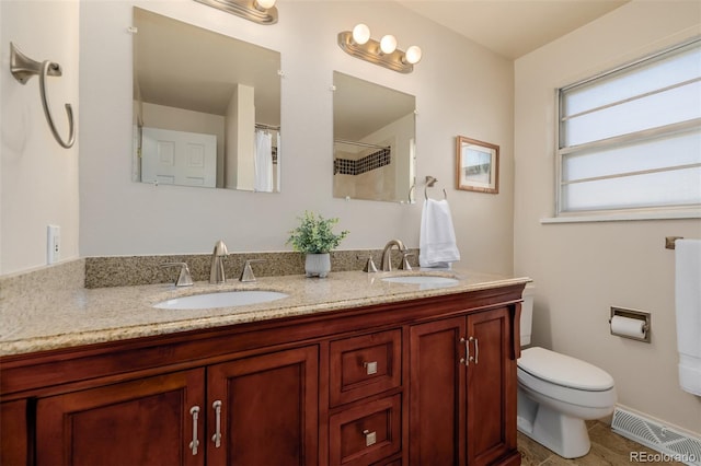 bathroom featuring vanity and toilet