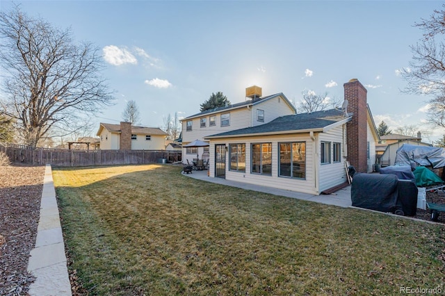 rear view of house featuring a patio area and a lawn