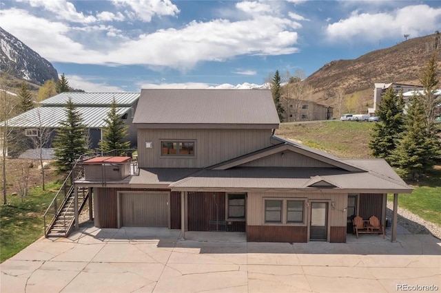 13 Paradise Rd, Crested Butte, CO 81225 - back of property featuring a mountain view, stairway, and an attached garage