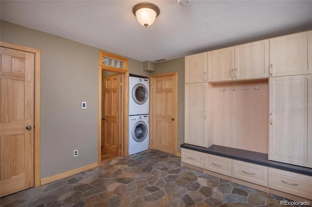 13 Paradise Rd, Crested Butte, CO 81225 - laundry room featuring stacked washing machine and dryer and stone flooring