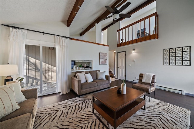 living room with plenty of natural light, a baseboard radiator, beam ceiling, and wood finished floors