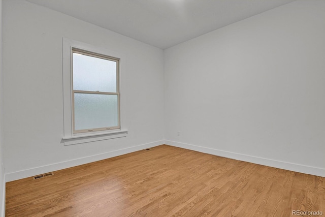 empty room with light hardwood / wood-style floors