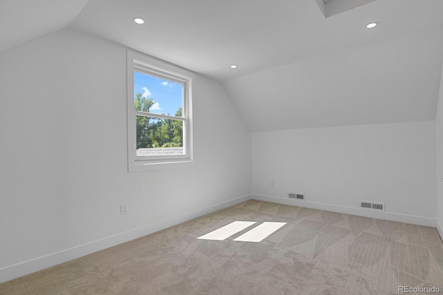 additional living space with lofted ceiling and light carpet