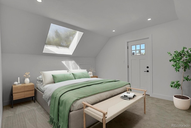 carpeted bedroom featuring lofted ceiling with skylight