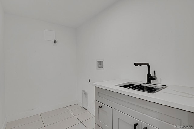 laundry room featuring hookup for a washing machine, light tile patterned floors, sink, and hookup for an electric dryer