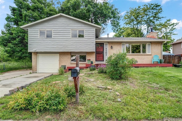 1161 S Johnson Way, Lakewood, CO 80232 - split level home with brick siding, concrete driveway, a front lawn, and a garage