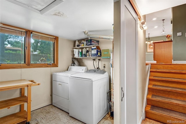 1161 S Johnson Way, Lakewood, CO 80232 - laundry room featuring separate washer and dryer, light floors, and a chandelier