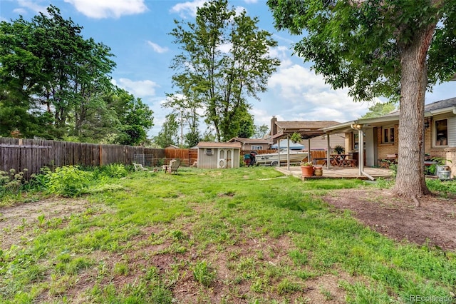 1161 S Johnson Way, Lakewood, CO 80232 - fenced backyard featuring a storage shed and a patio