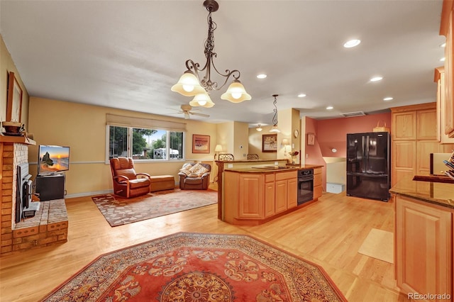 1161 S Johnson Way, Lakewood, CO 80232 - kitchen featuring black appliances, light wood-type flooring, open floor plan, a chandelier, and recessed lighting