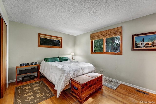 1161 S Johnson Way, Lakewood, CO 80232 - bedroom with wood finished floors, a textured ceiling, and a closet
