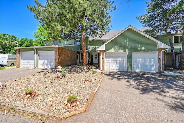 1711 Cato Cir Unit 21, Lafayette, CO 80026 - traditional-style house with brick siding, driveway, and an attached garage