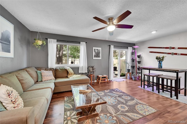 1711 Cato Cir Unit 21, Lafayette, CO 80026 - living area with a textured ceiling, a ceiling fan, healthy amount of natural light, and wood finished floors