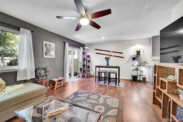 1711 Cato Cir Unit 21, Lafayette, CO 80026 - living area featuring a ceiling fan, plenty of natural light, a textured ceiling, and wood finished floors