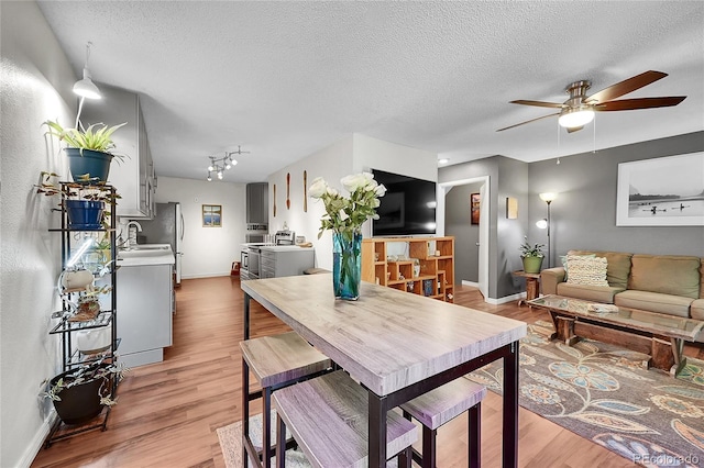 1711 Cato Cir Unit 21, Lafayette, CO 80026 - dining room with a ceiling fan, light wood finished floors, a textured ceiling, and track lighting