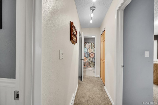 1711 Cato Cir Unit 21, Lafayette, CO 80026 - hallway featuring light colored carpet and a textured ceiling