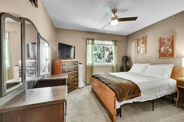 1711 Cato Cir Unit 21, Lafayette, CO 80026 - bedroom featuring light carpet, a textured ceiling, and a ceiling fan
