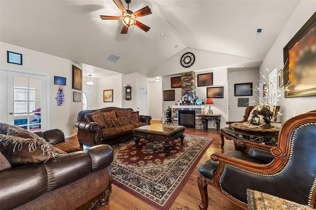 living room with lofted ceiling, wood-type flooring, and ceiling fan