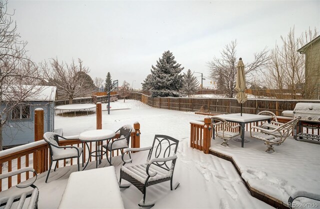 snow covered patio with a trampoline