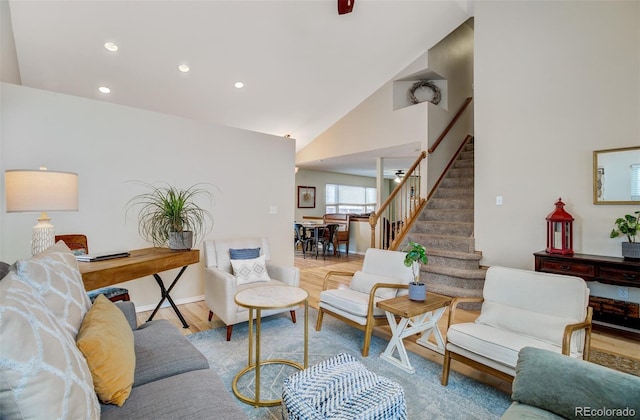 living room featuring vaulted ceiling and light wood-type flooring