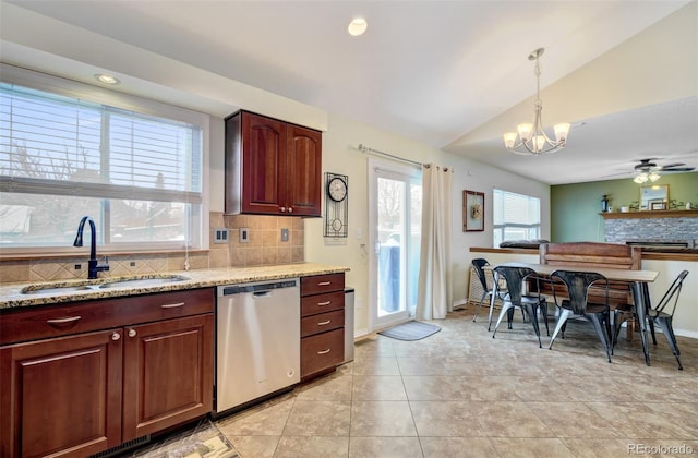 kitchen with dishwasher, ceiling fan with notable chandelier, sink, vaulted ceiling, and decorative light fixtures