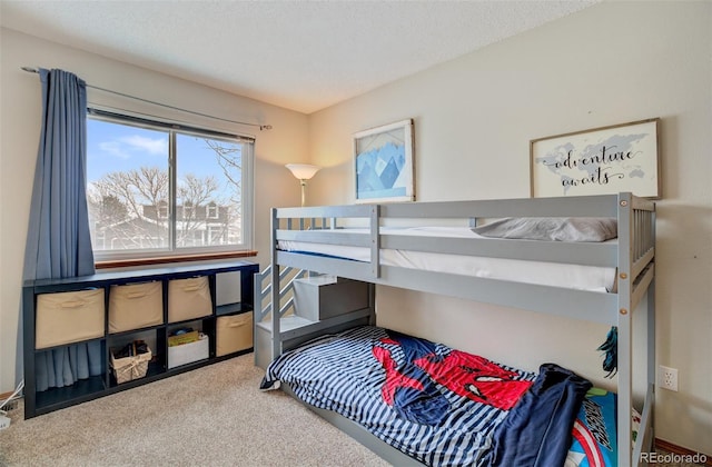 bedroom with carpet floors and a textured ceiling