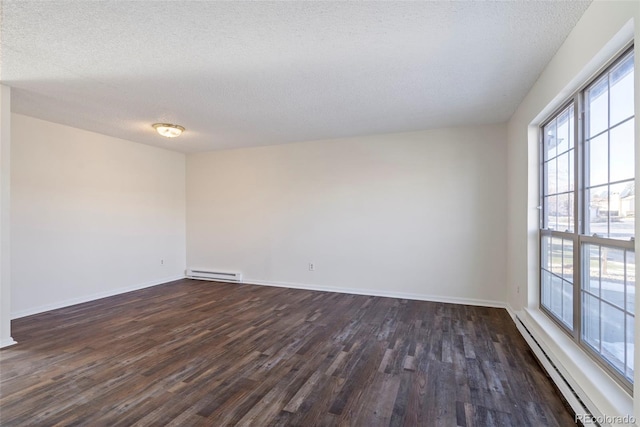 unfurnished room with a healthy amount of sunlight, dark hardwood / wood-style floors, and a baseboard heating unit