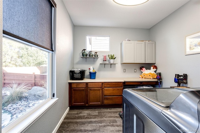 kitchen with independent washer and dryer and dark hardwood / wood-style floors