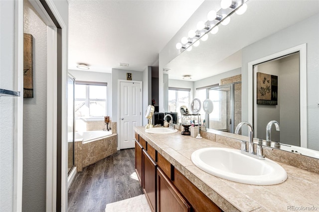 bathroom with vanity, hardwood / wood-style flooring, and shower with separate bathtub