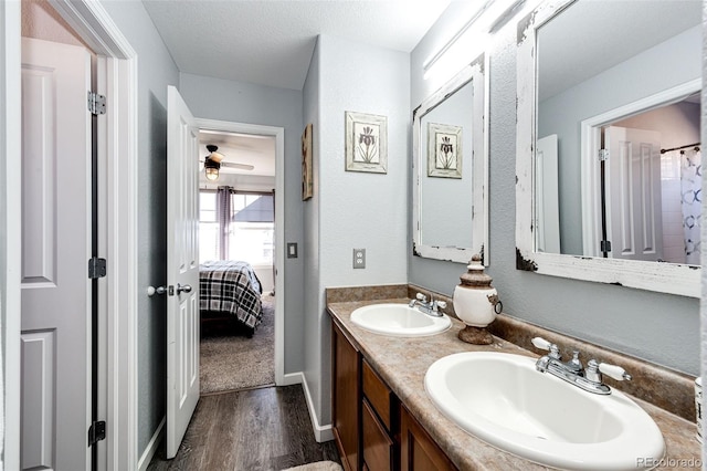 bathroom featuring vanity, hardwood / wood-style floors, and a textured ceiling