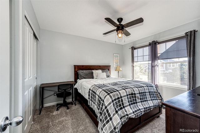 carpeted bedroom featuring ceiling fan and a closet