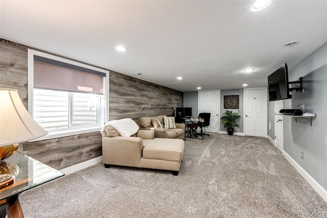 living room with wooden walls and carpet