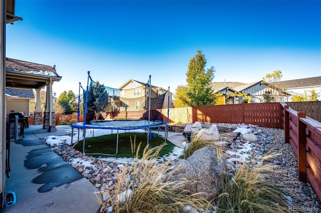 view of pool with a trampoline and a patio area