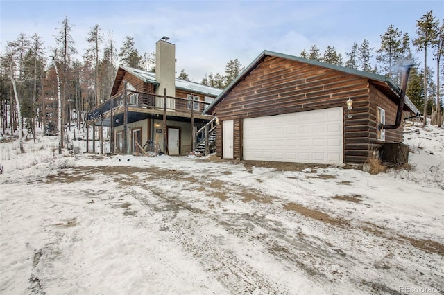 exterior space featuring a garage and a deck