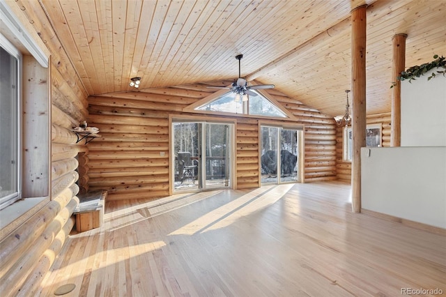 unfurnished living room featuring hardwood / wood-style floors, vaulted ceiling with beams, rustic walls, and wood ceiling