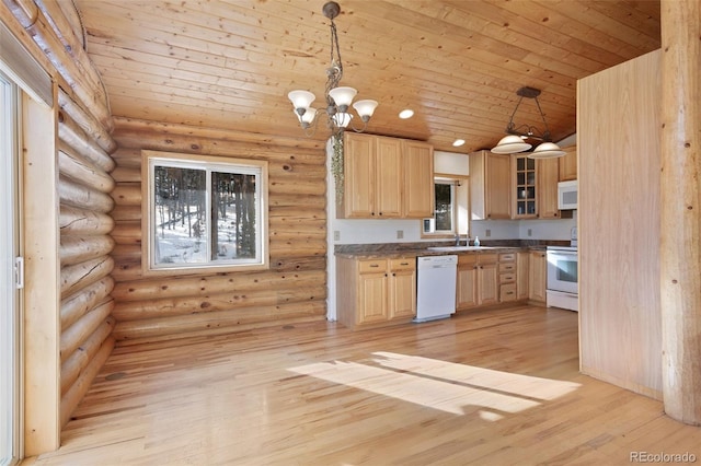 kitchen featuring decorative light fixtures, white appliances, light brown cabinetry, and rustic walls