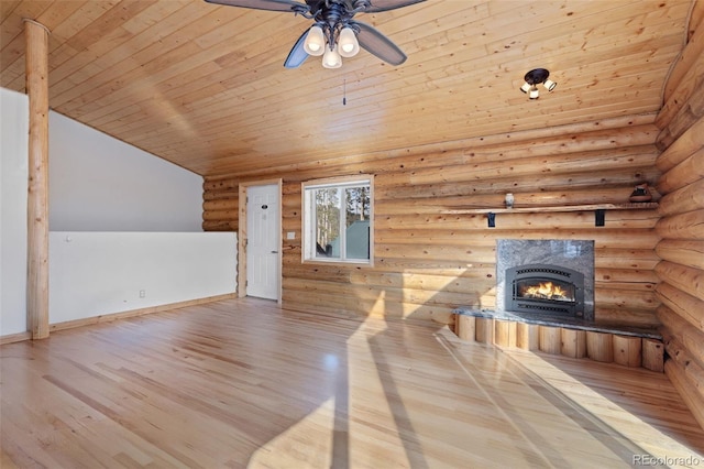 unfurnished living room with wood ceiling, a fireplace, light hardwood / wood-style floors, rustic walls, and lofted ceiling