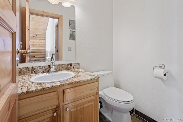 bathroom featuring toilet and vanity