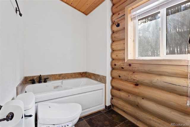 bathroom with wooden ceiling, a washtub, log walls, and a healthy amount of sunlight