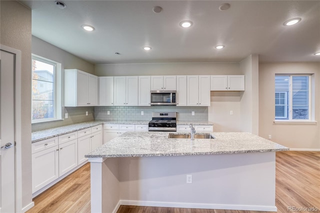 23981 E 40th Ave, Aurora, CO 80019 - kitchen featuring appliances with stainless steel finishes, white cabinets, backsplash, and recessed lighting