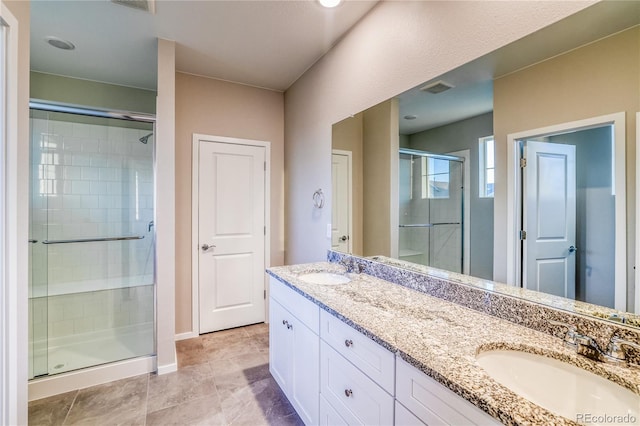 23981 E 40th Ave, Aurora, CO 80019 - full bathroom featuring a shower stall, double vanity, and tile patterned flooring