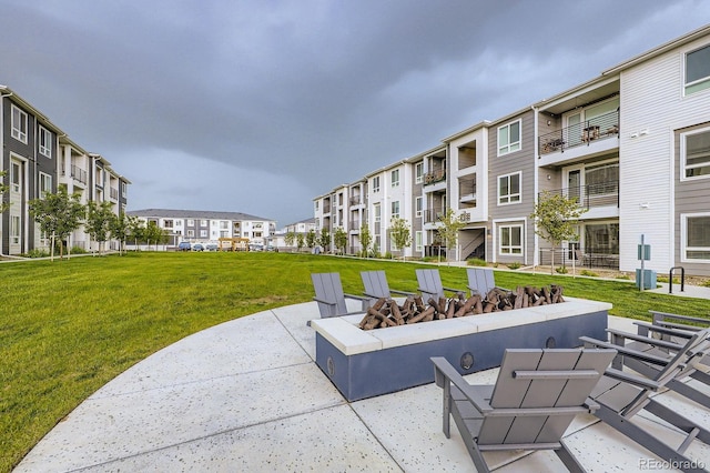 6153 N Ceylon St Unit 2-202, Denver, CO 80249 - view of community featuring a yard, a residential view, a fire pit, and a patio area