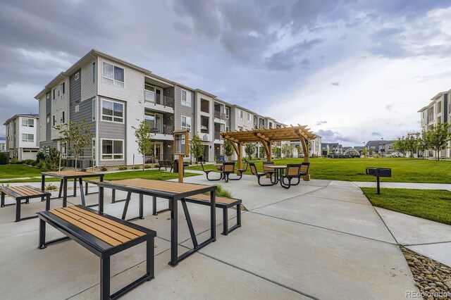 6153 N Ceylon St Unit 2-202, Denver, CO 80249 - view of home's community with a pergola, a yard, and a residential view