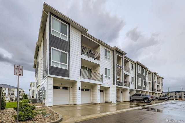 6153 N Ceylon St Unit 2-202, Denver, CO 80249 - view of building exterior with a garage