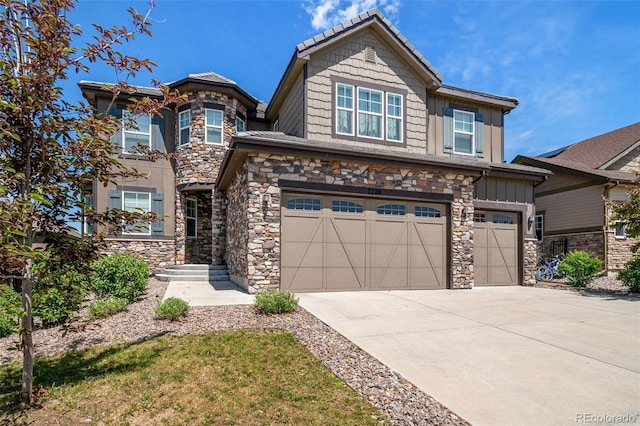 7720 S Queensburg Way, Aurora, CO 80016 - view of front of home featuring an attached garage, stone siding, concrete driveway, and board and batten siding