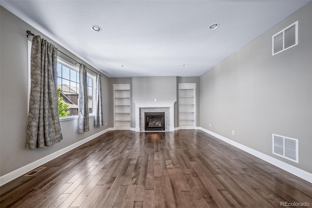 7720 S Queensburg Way, Aurora, CO 80016 - unfurnished living room featuring dark wood finished floors, baseboards, built in features, a fireplace, and recessed lighting