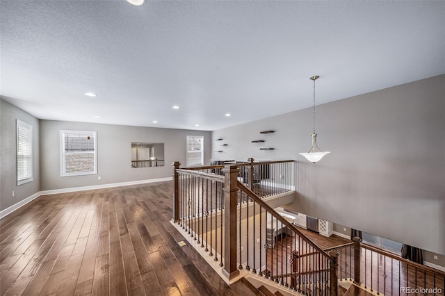 7720 S Queensburg Way, Aurora, CO 80016 - hallway with an upstairs landing, wood finished floors, baseboards, and recessed lighting