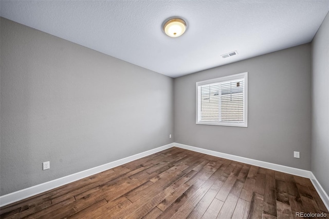7720 S Queensburg Way, Aurora, CO 80016 - unfurnished room with dark wood-style flooring and baseboards