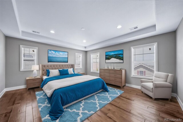 7720 S Queensburg Way, Aurora, CO 80016 - bedroom featuring a raised ceiling, baseboards, hardwood / wood-style floors, and recessed lighting