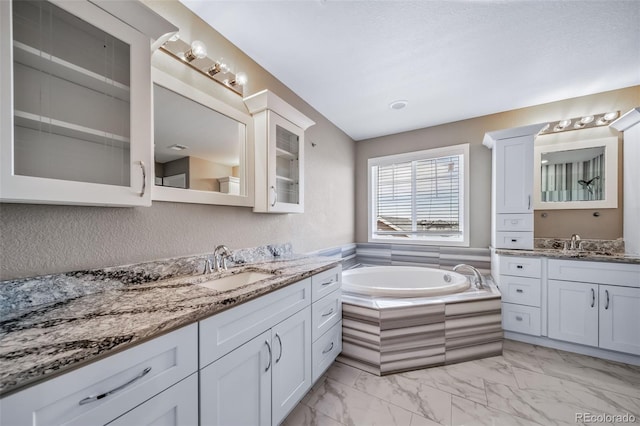 7720 S Queensburg Way, Aurora, CO 80016 - full bath featuring marble look tile flooring, two vanities, and a bath